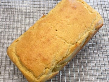 The cake is cooling directly on the wire rack.