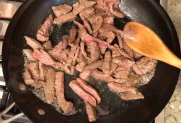 Cooking the beef in the skillet.