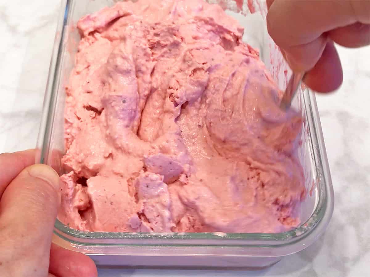 Stirring the ice cream.