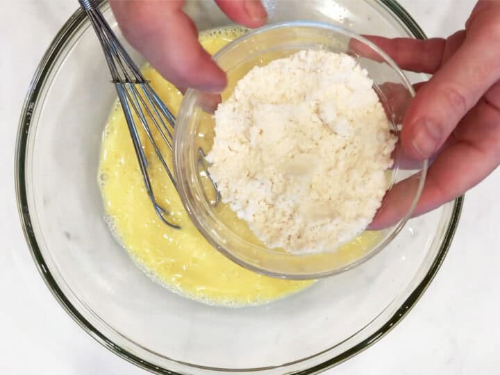 Adding coconut flour to the batter.