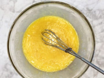 Whisking the wet ingredients in a bowl.