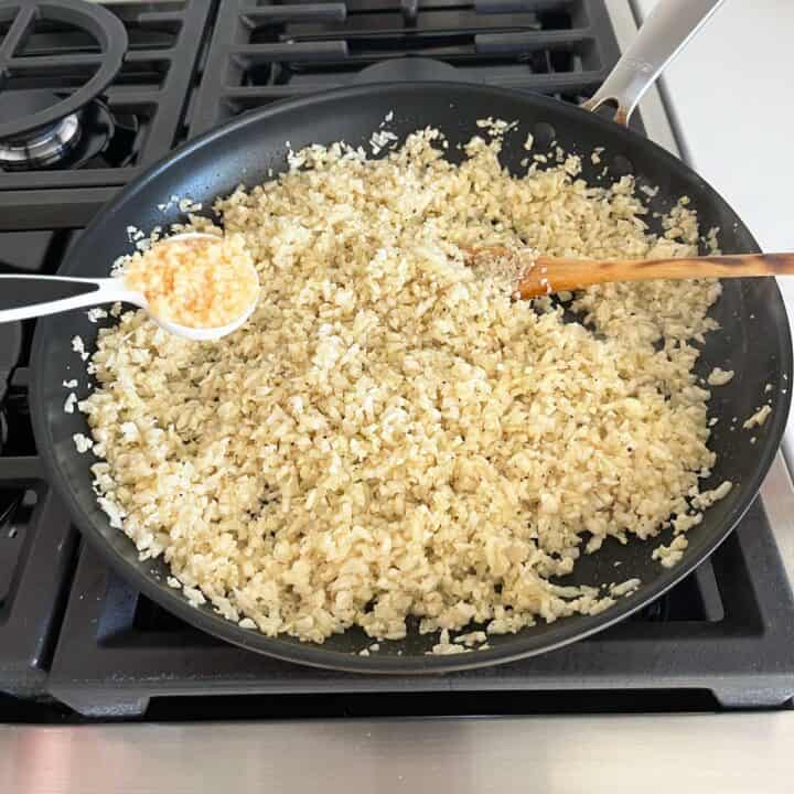 Adding garlic to the skillet.