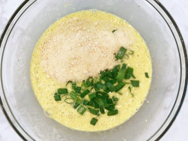 Adding parmesan and scallions.