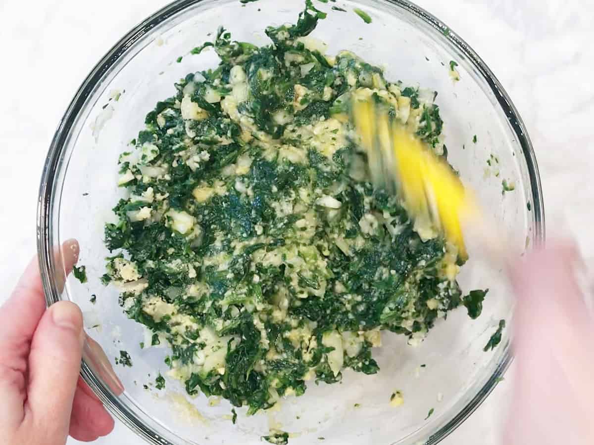 Mixing in flour and cheese.