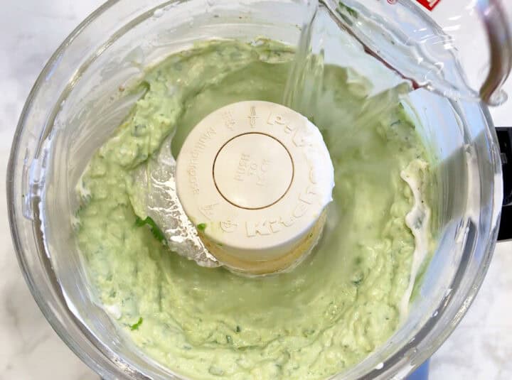 Adding water to the mixture.