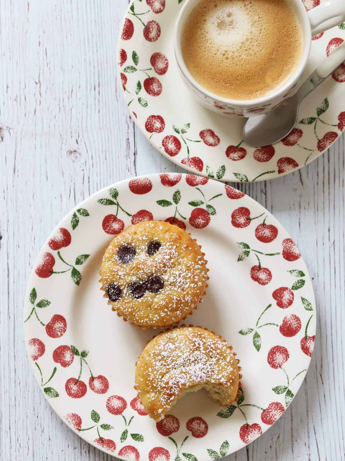 Two almond flour muffins are served with coffee.