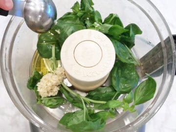 Basil, garlic, and olive oil in the food processor.