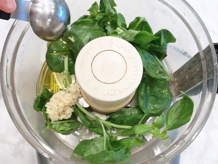 Basil, garlic, and olive oil in the food processor.