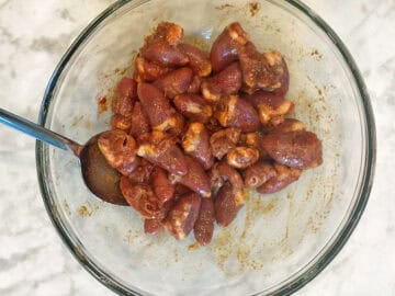 Coating the hearts in the oll and spices.