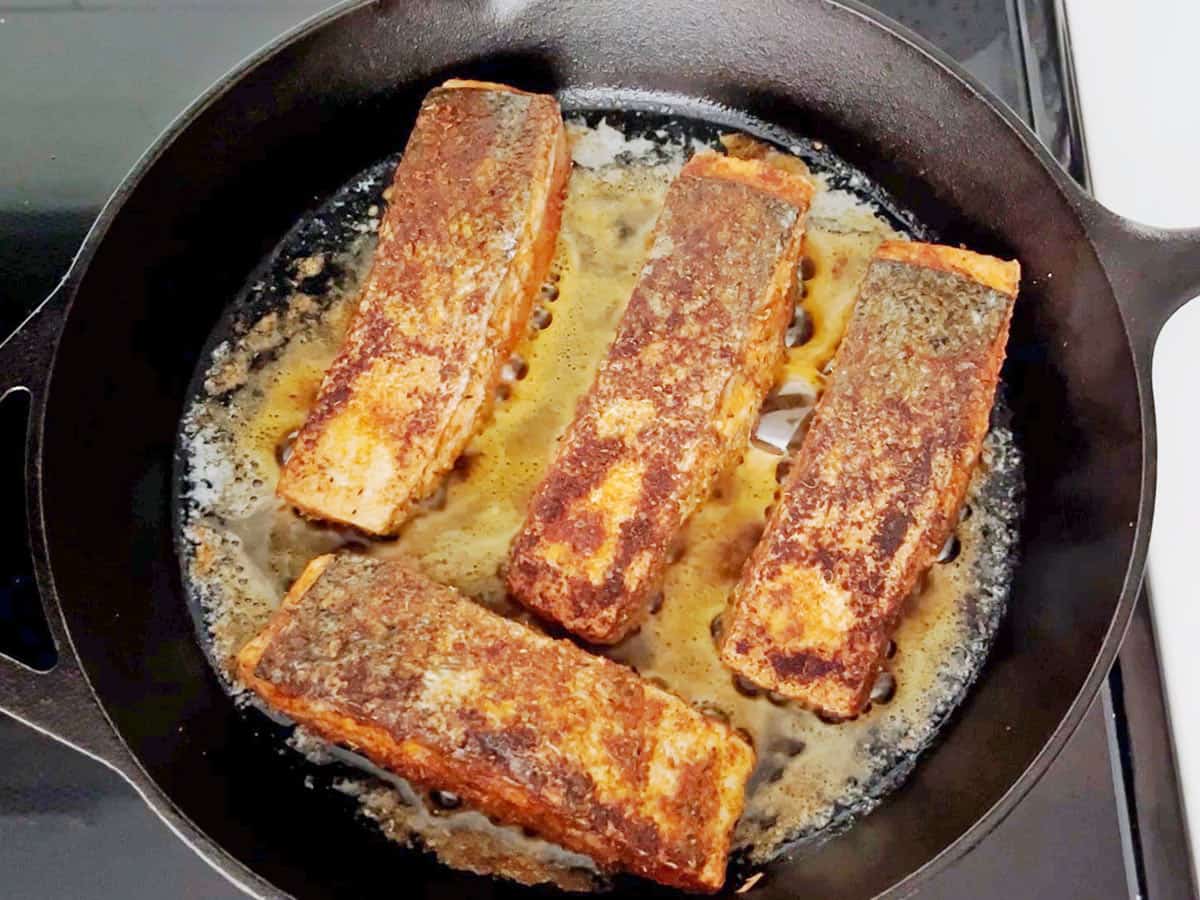 Cooking the salmon on the second side.