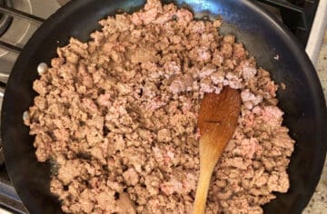 Cooking the ground beef.