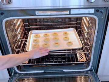 Placing the cookies in the oven.