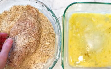 Dredging the chicken in almond meal.