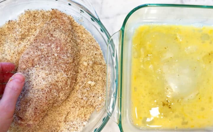 Dredging the chicken in almond meal.