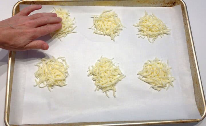 Flattening the cheese mounds.