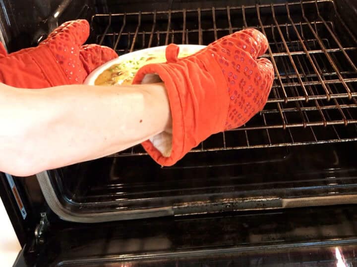 Placing the frittata in the oven.