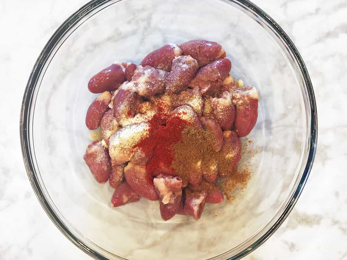 Hearts, olive oil, and spices in a bowl.