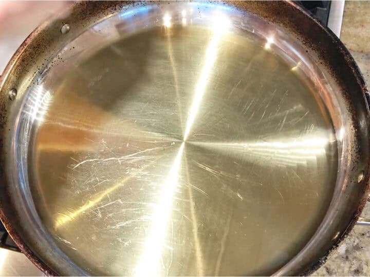 Heating the oil in the skillet.