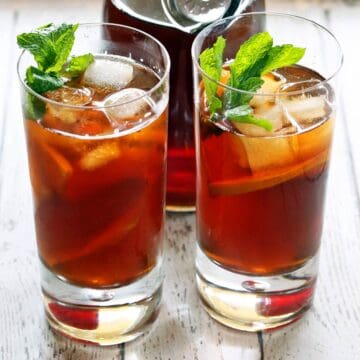 Iced tea is garnished with mint leaves.