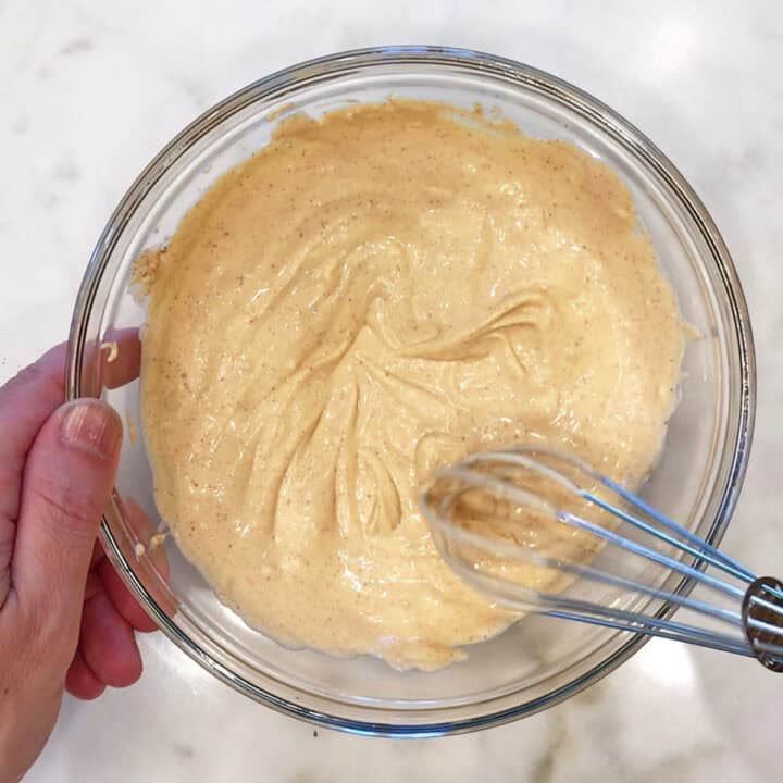 Mixing cream cheese, mayo, Dijon, and spices in a bowl.