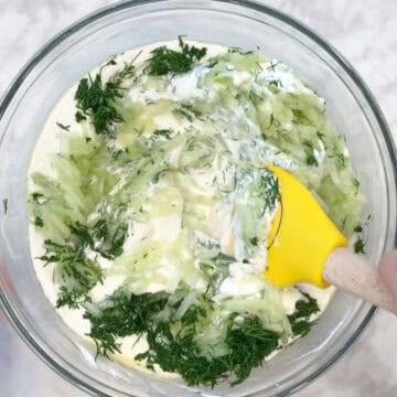 Mixing the tzatziki.