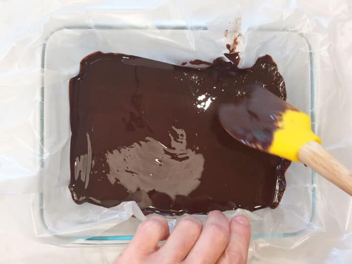 Transferring the mixture to the lined pan.