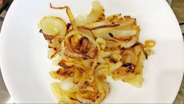 Sauteed onions on a white plate.