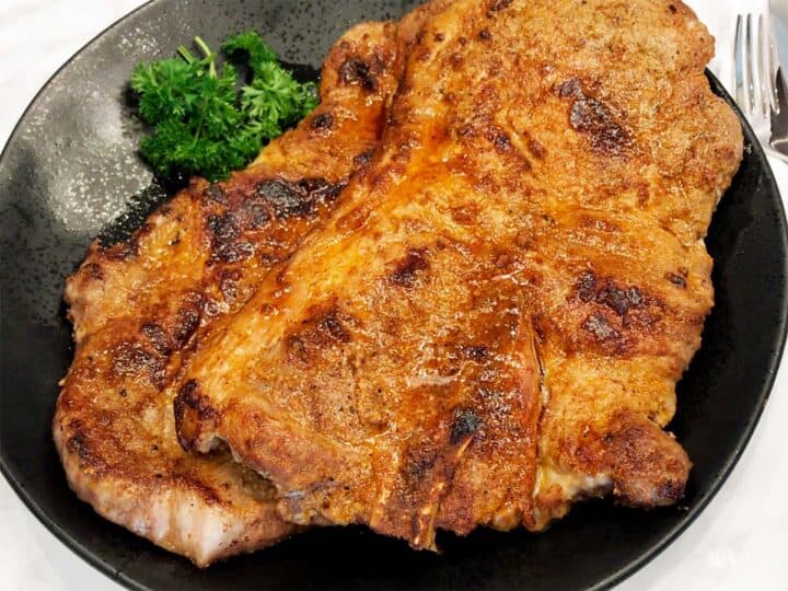 The steaks are served on a plate.