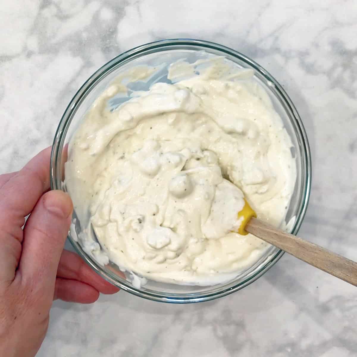 Mixing in the blue cheese.