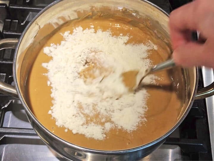 Adding coconut flour to the mixture.