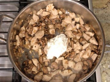 Adding the sour cream to the skillet.