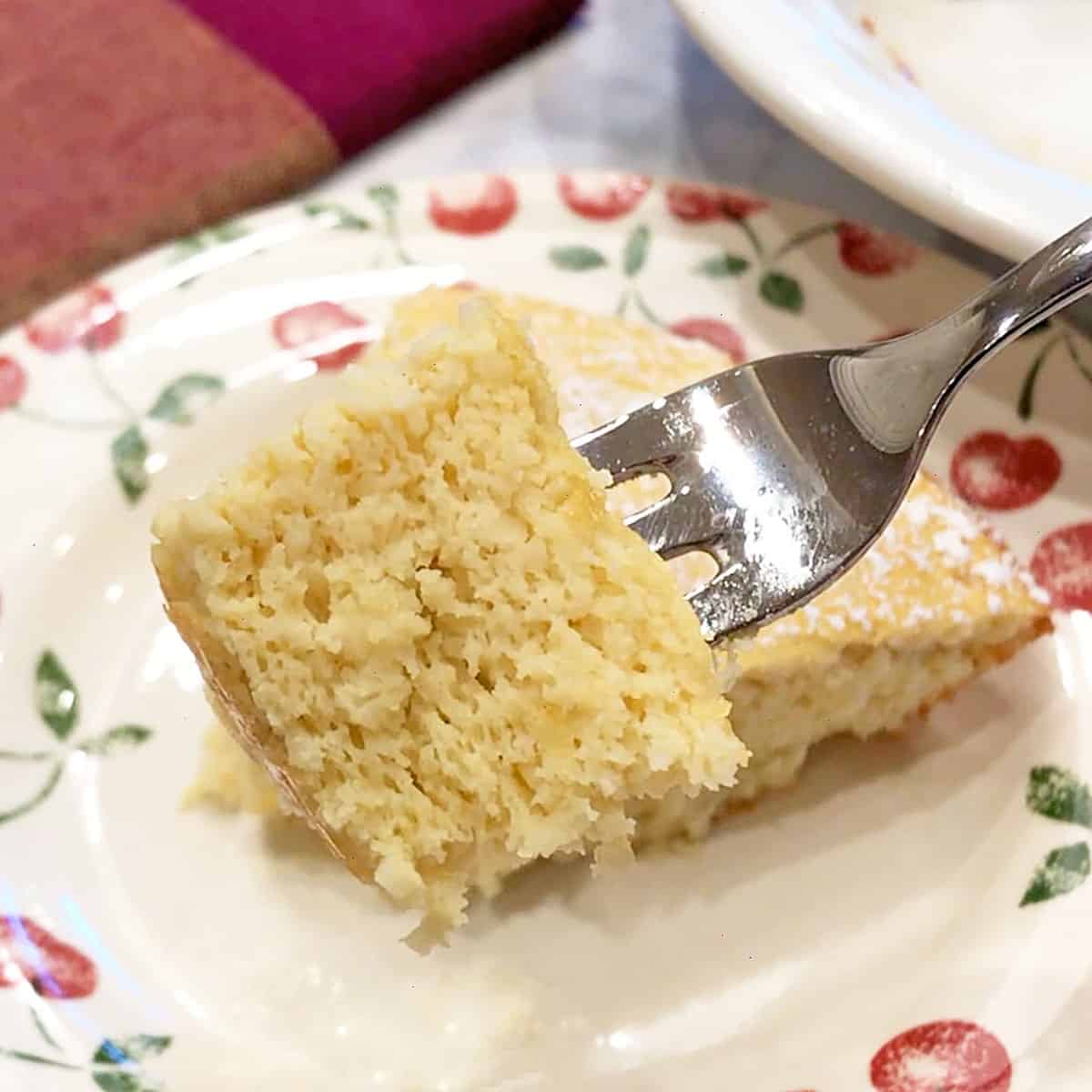 A fork showing off the cake's moist and tender crumb.