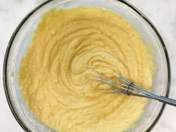 Mixing the dry ingredients into the batter.