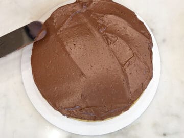 Frosting the second layer of the cake.