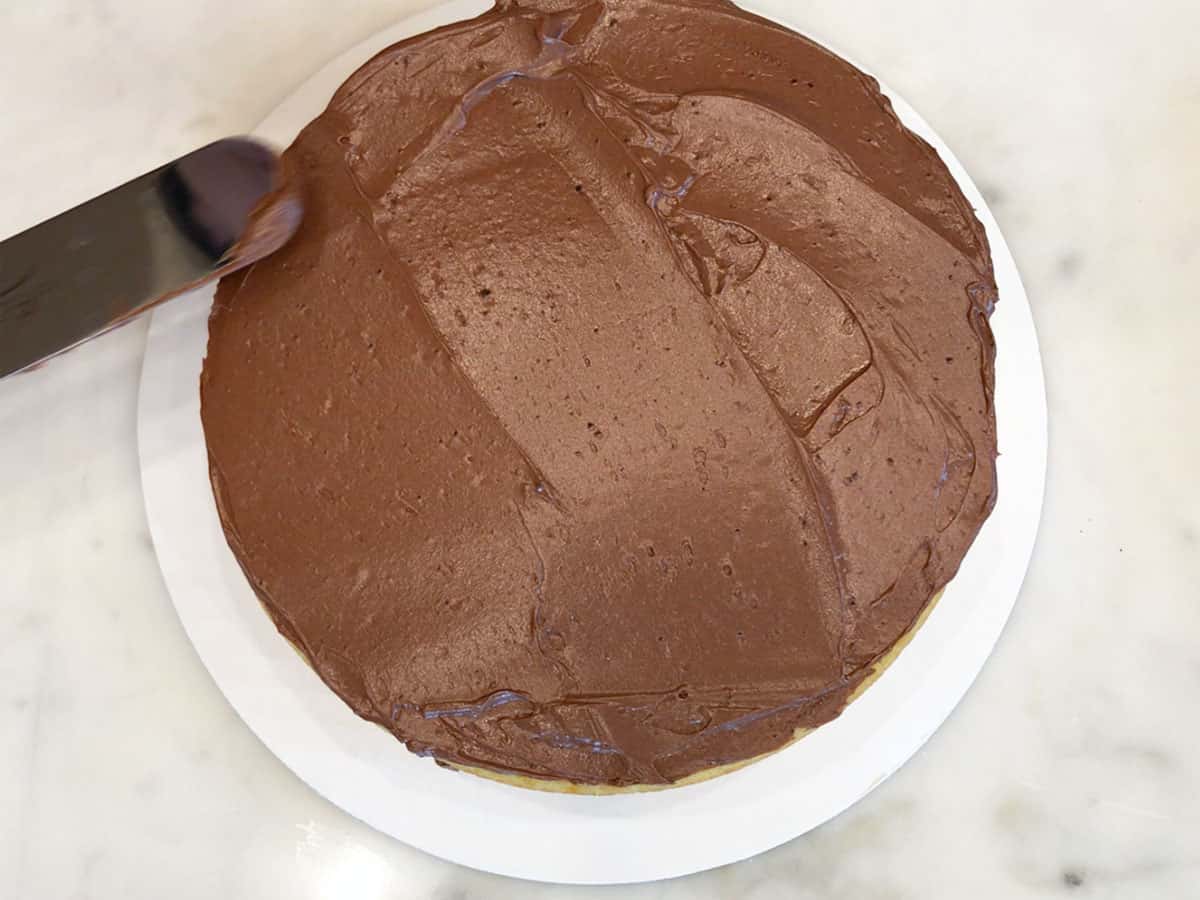 Frosting the second layer of the cake.