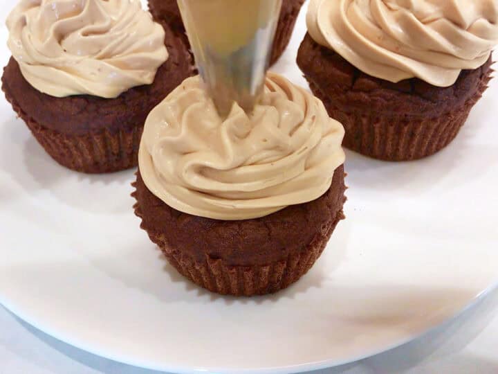 Frosting the cupcakes.