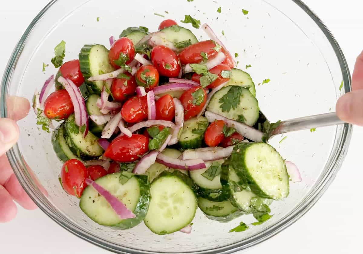 Mixing the salad in a bowl.