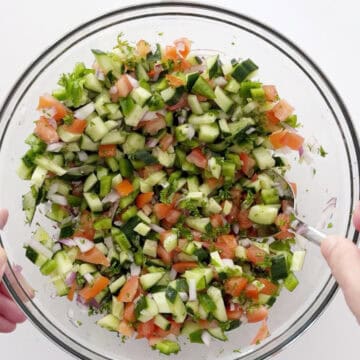 Mixing the veggies in a bowl.