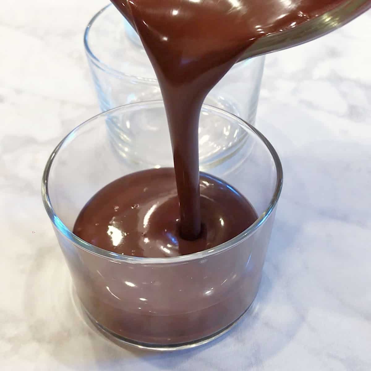 Pouring the pudding mixture into dessert cups.