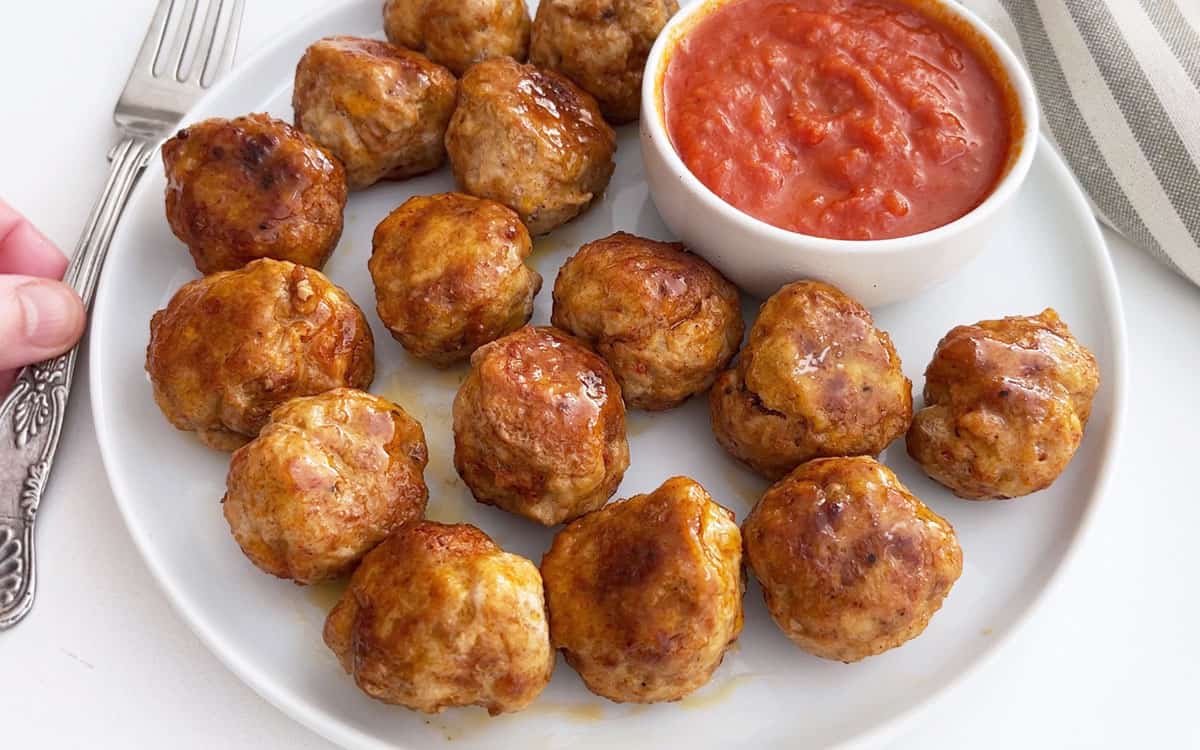 The meatballs are served with a dipping sauce.