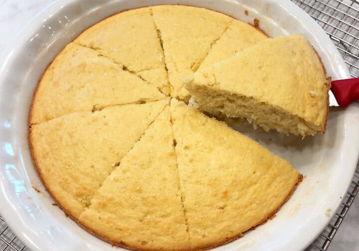 Slicing the cake in the pan.