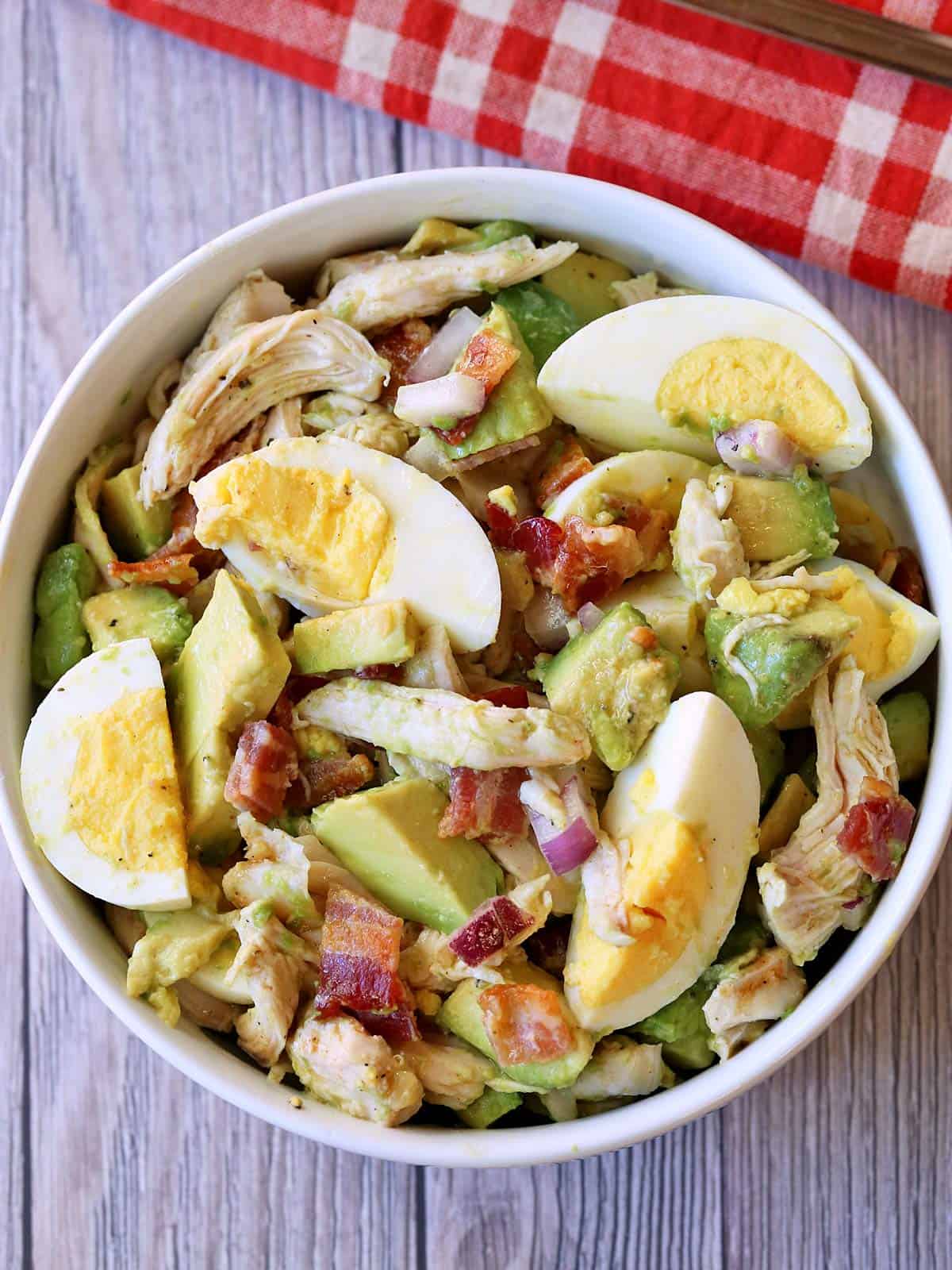 Avocado chicken salad is served in a white bowl.
