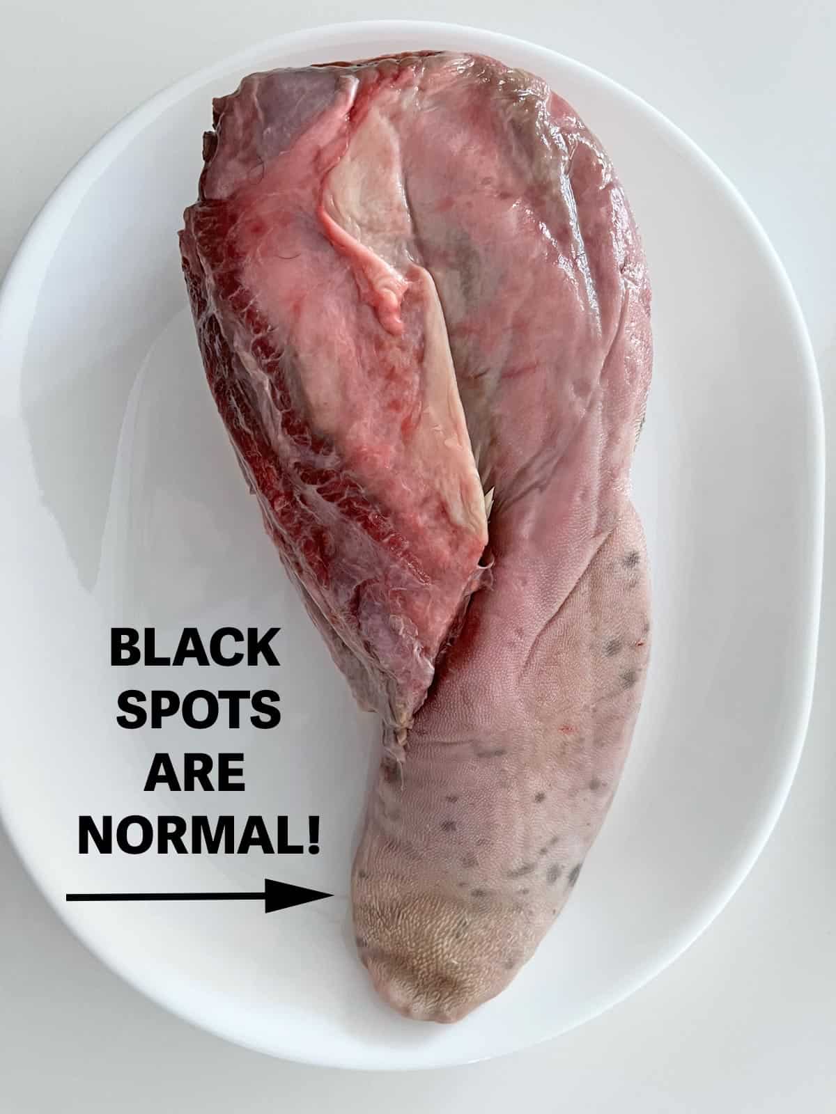 A beef tongue with black spots.