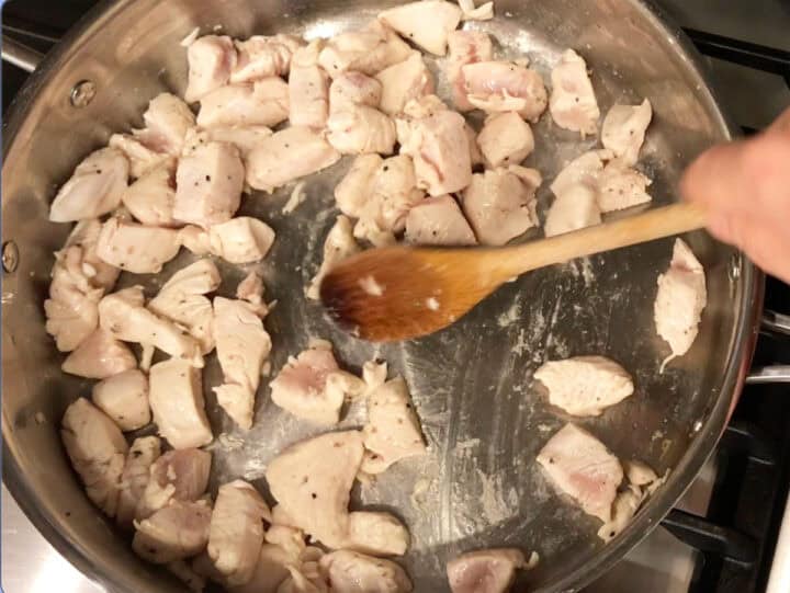 Sauteing the chicken in a skillet.