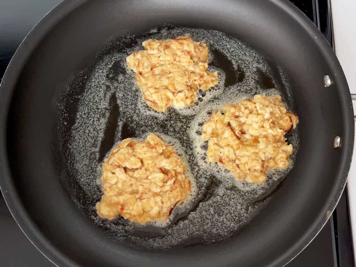 Cooking the matzo brei in butter in a skillet.