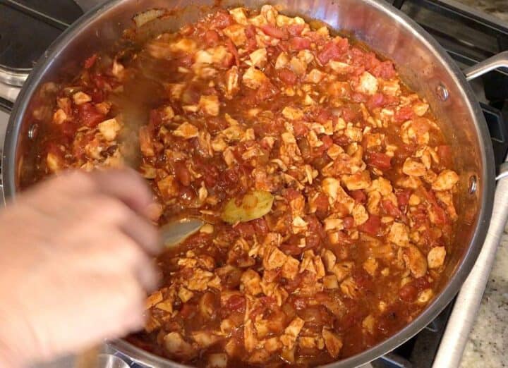 Simmering the chili in a saucepan.