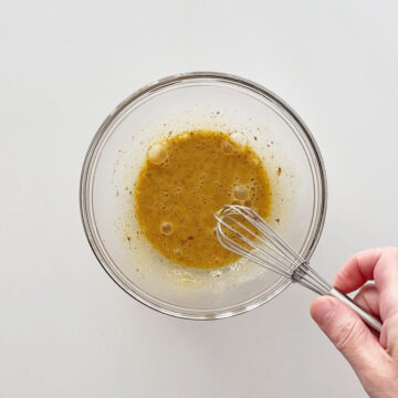 Mixing an egg with cinnamon and vanilla.