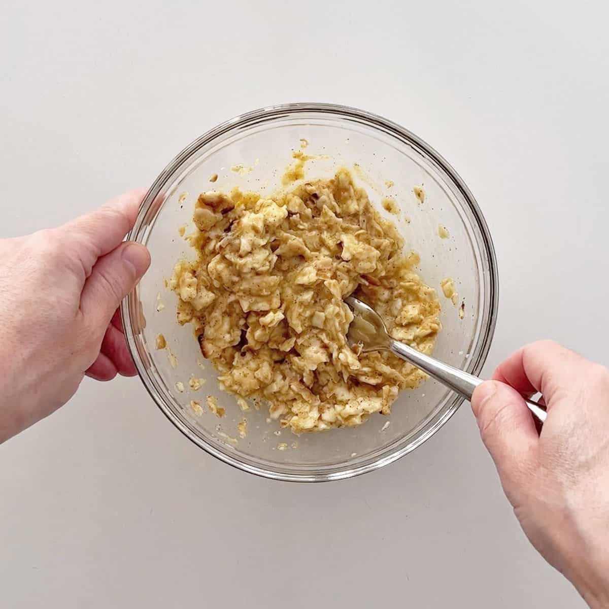 Adding the softened matzo to the egg mixture.