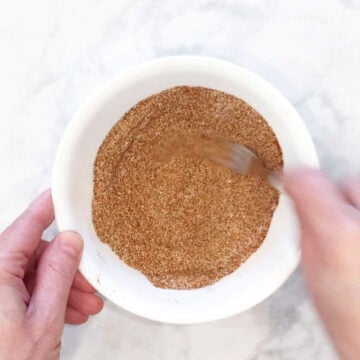 Mixing spices in a white bowl.