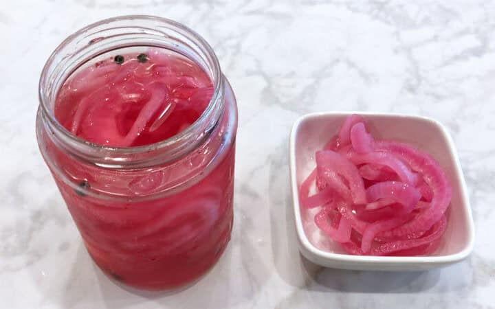 Pickled red onions are served.